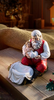 Adoring Santa with Baby Jesus Statue